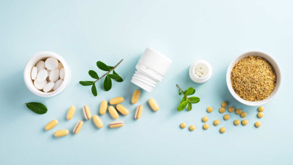 Various weight loss supplements including tablets, capsules, and herbal formulations with natural green leaves on light blue background