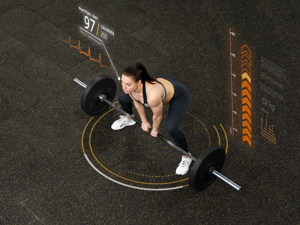 Woman weightlifting with digital workout stats overlay — showcasing exercise essentials