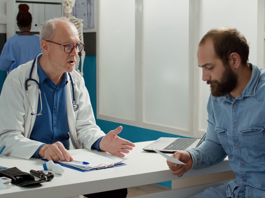 Physician explaining gut health treatment options to patient in medical office