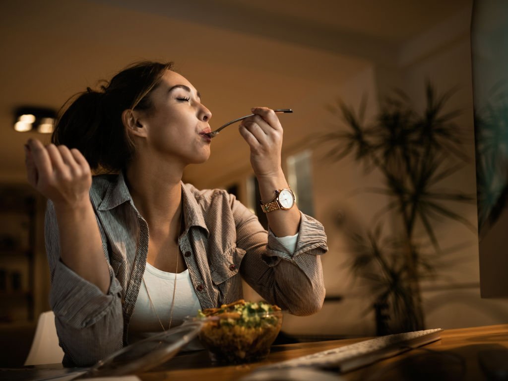 Woman practicing mindful eating and mealtime consciousness as part of holistic beauty routines for wellness
