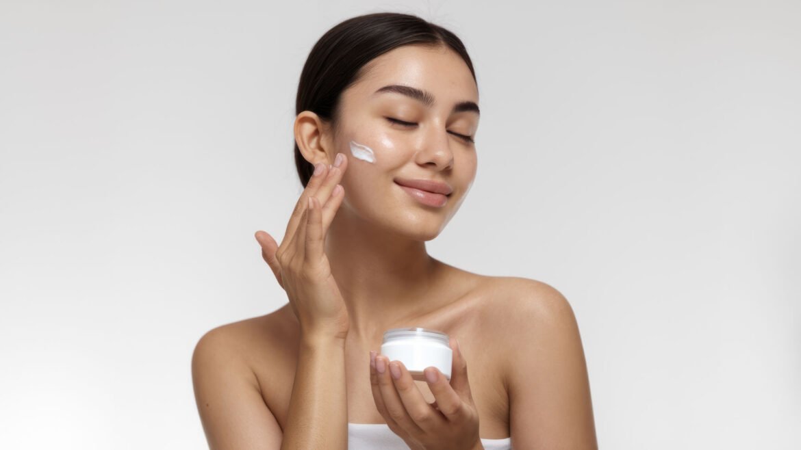 Woman applying skincare tips by gently massaging moisturizer on her face for radiant and healthy skin