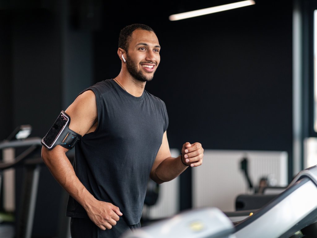 Man doing cardio treadmill workout to boost your metabolism and enhance weight loss in modern gym setting