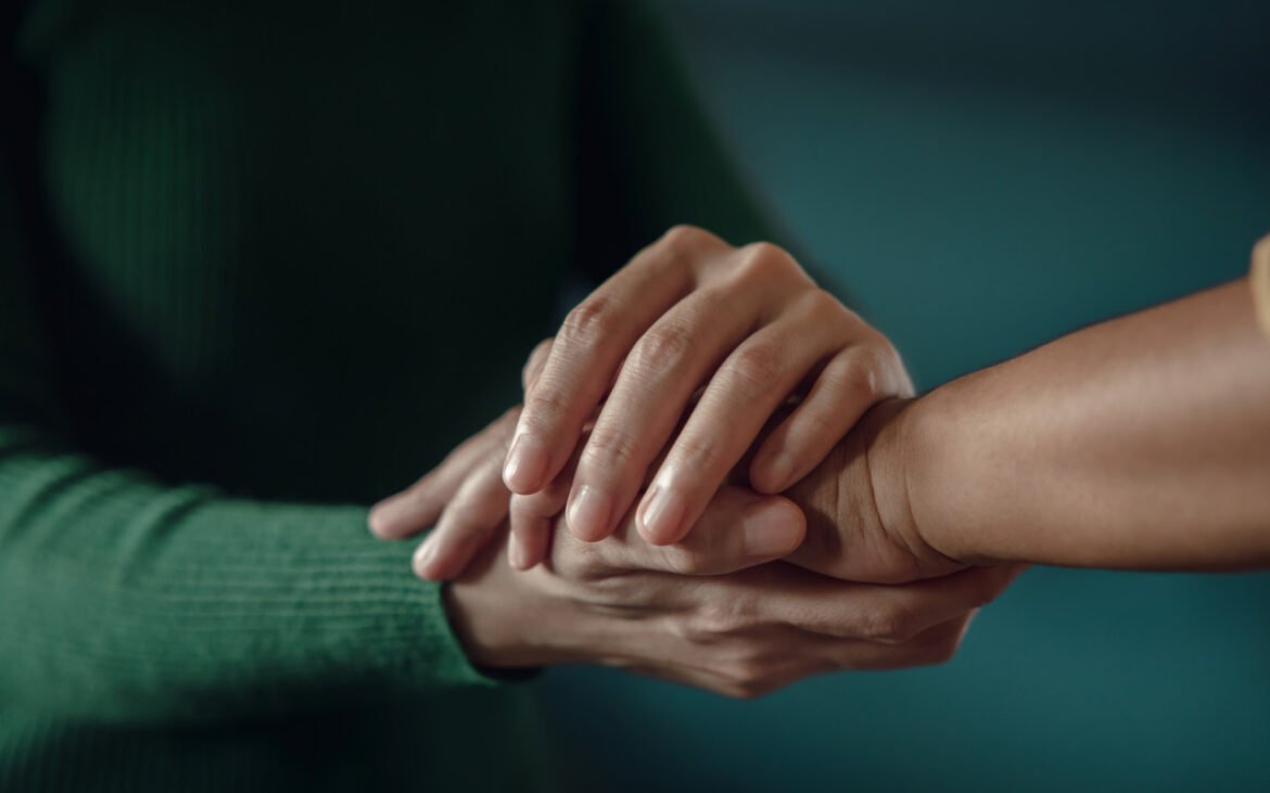 Overcoming anxiety through natural healing - supportive hands in gentle, therapeutic gesture representing calm and wellness