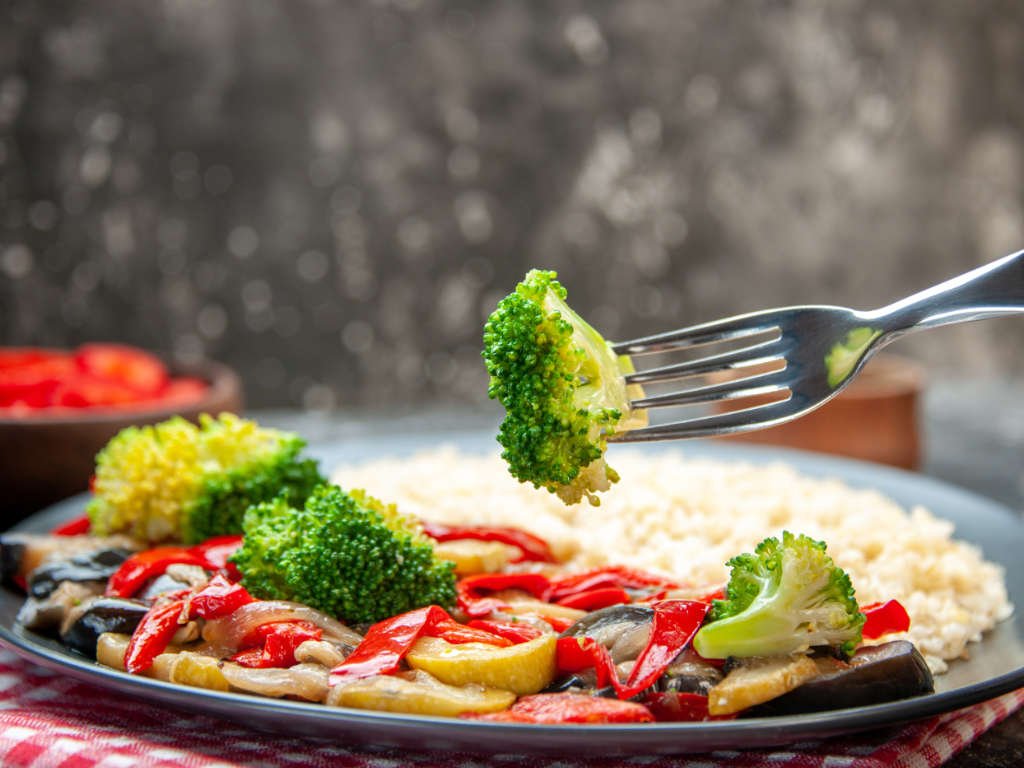 Colorful plate of vegetables and grains representing smart eating habits with balanced portions