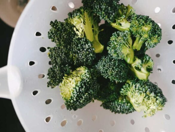 Fresh broccoli florets containing vitamin K for radiant skin support - essential vitamins for healthy skin and circulation