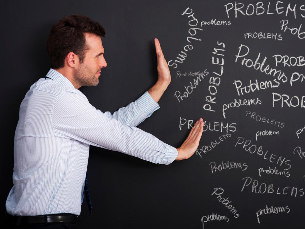 Man pushing away negative thoughts and problems as part of mental health strategies for challenging thought patterns