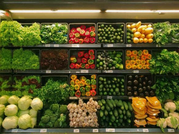 Organized display of fresh vegetables in grocery store showing essential food groups for balanced nutrition and healthy eating