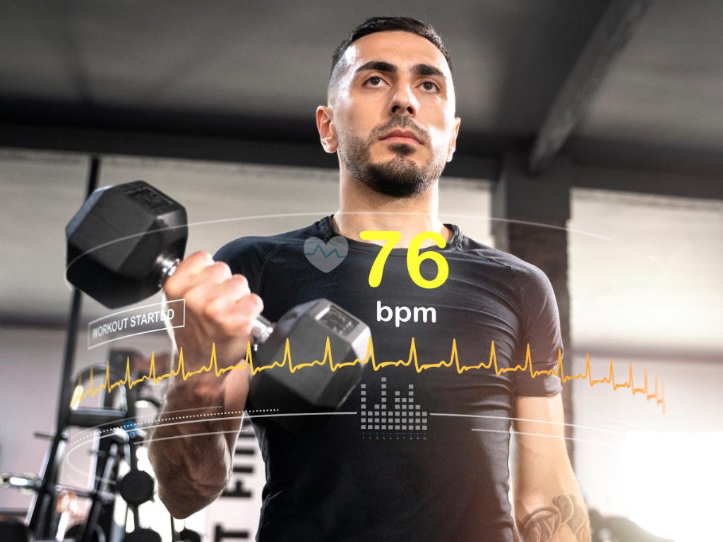 Man performing cardio exercises with heart rate monitor showing 76 bpm and heart rate zones tracking