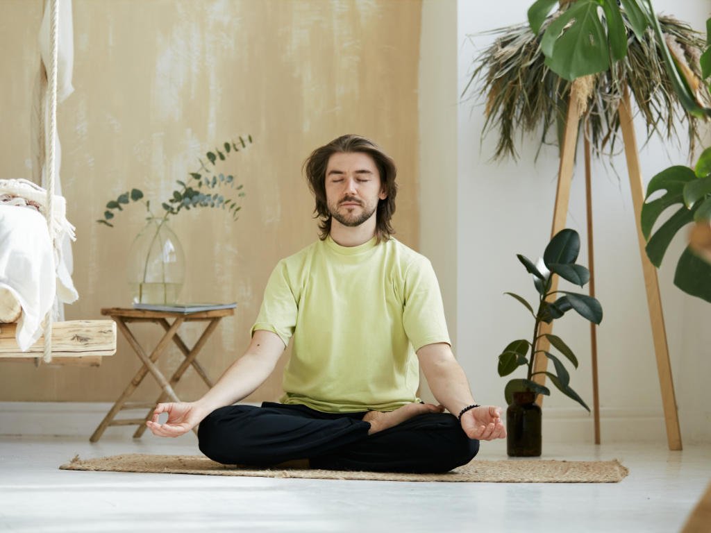 Person practicing yoga meditation for mental clarity in peaceful indoor setting