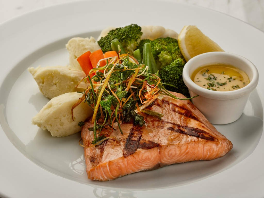 Mediterranean diet benefits for fighting inflammation featuring grilled salmon rich in omega-3 fatty acids served with fresh broccoli and vegetables