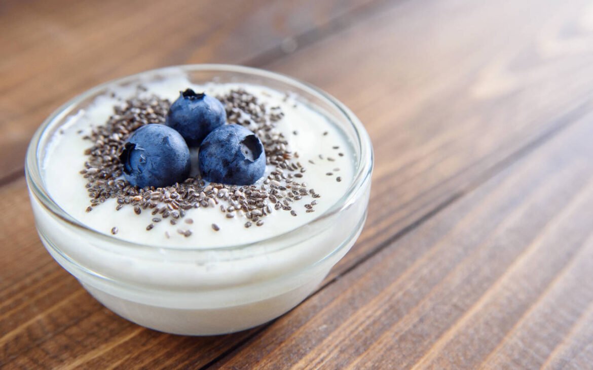 Bowl of creamy yogurt topped with fresh blueberries and chia seeds showcasing superfoods for daily nutrition optimization