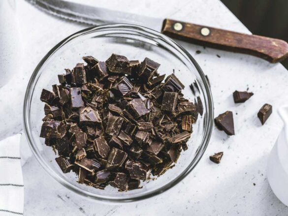 Chopped dark chocolate in glass bowl highlighting antioxidant superfoods for healthy daily nutrition
