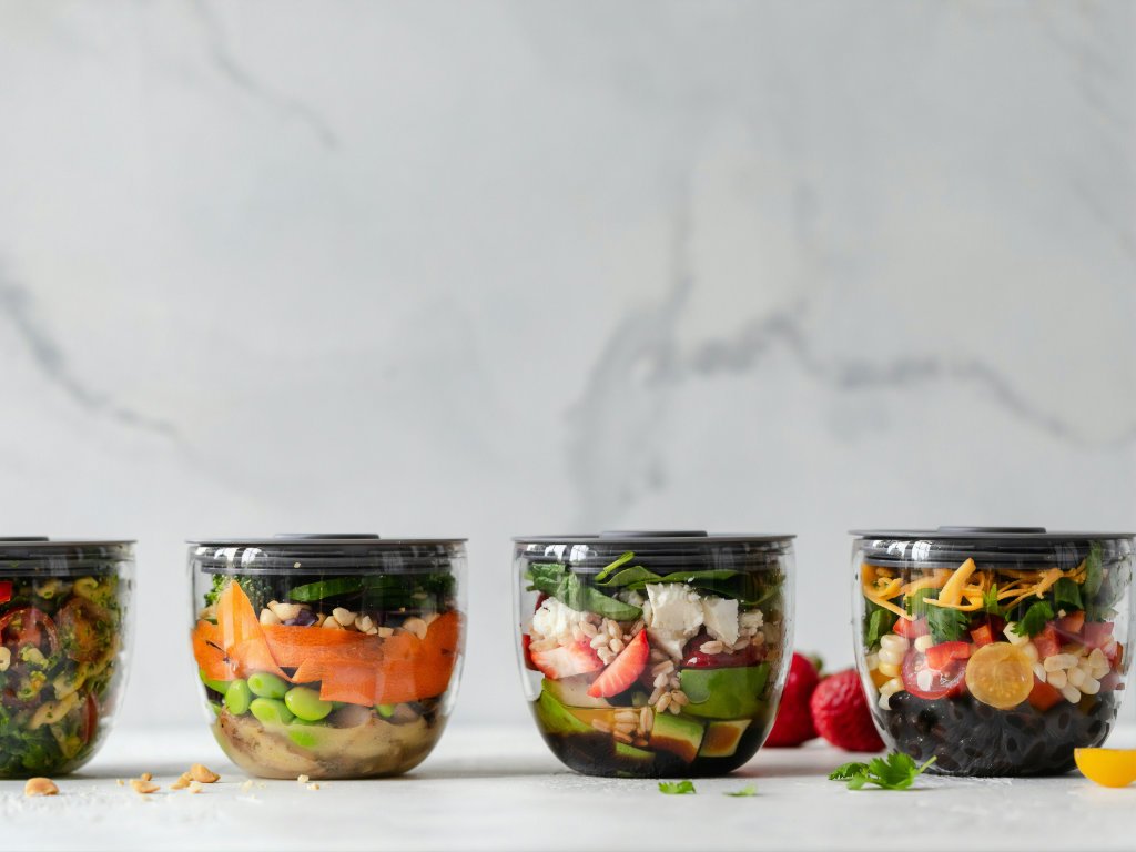 Exciting meal planning with four diverse colorful salad jars showcasing food variety for optimal health and nutrition