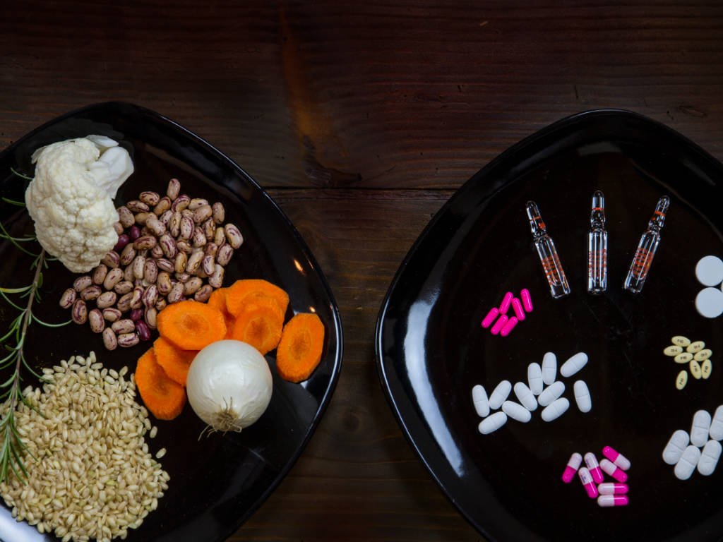 Natural whole foods including beans, vegetables, and grains compared to pharmaceutical pills and capsules as appetite suppressants alternatives