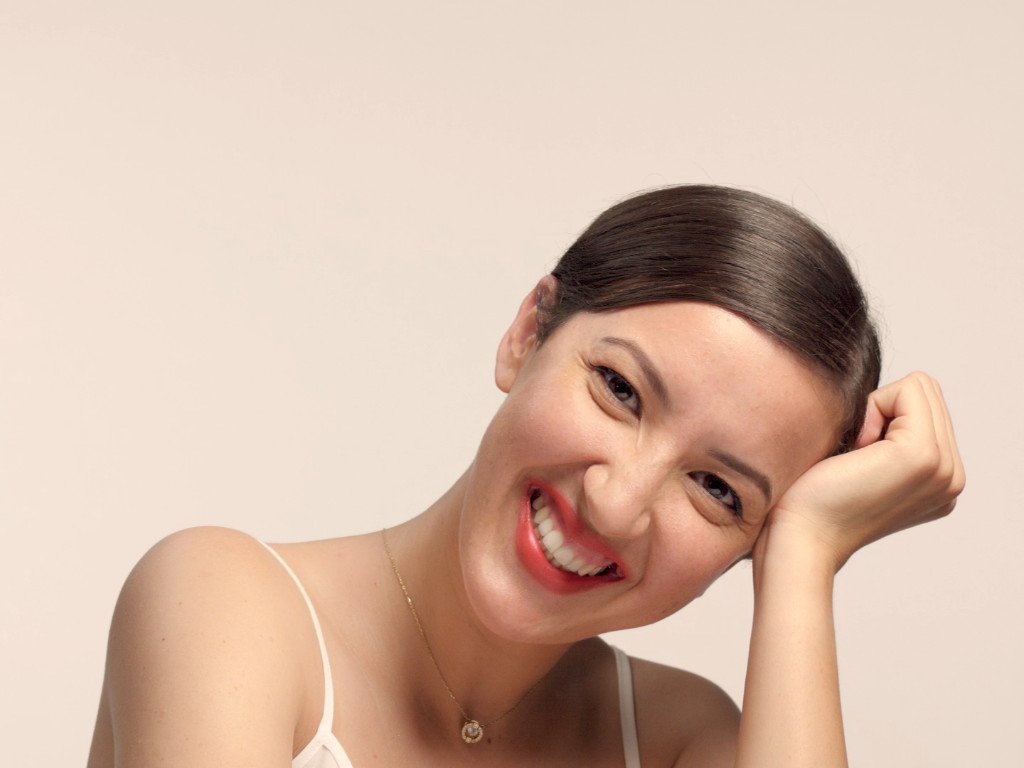 Woman with radiant glowing skin showcasing the benefits of smoothies for skin health and proper nutrition