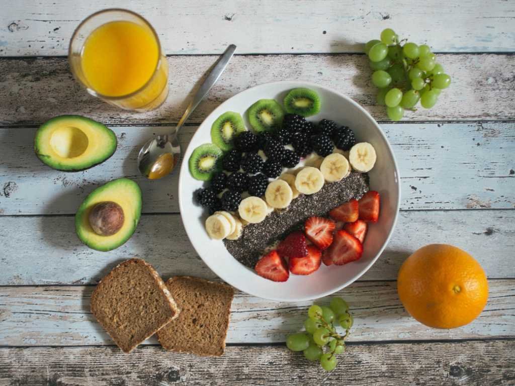 Healthy breakfast bowl with mood-supporting foods as part of daily emotional wellness techniques, featuring berries, avocado, and whole grains for mental health