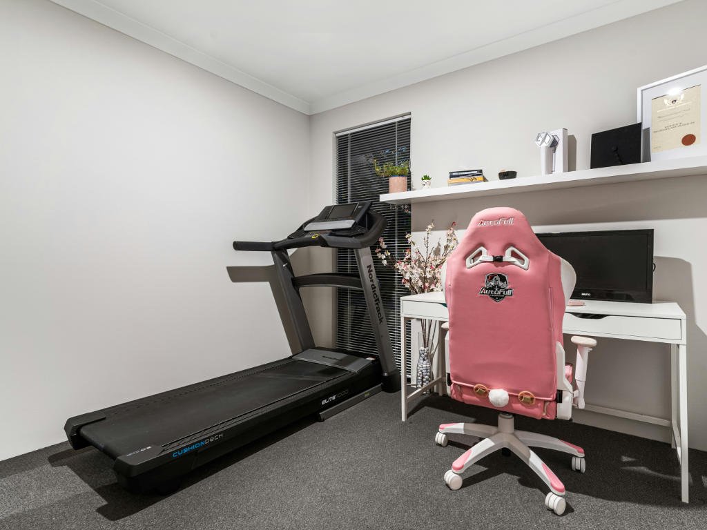 Modern home gym setup showcasing convenient fitness gadgets for women including smart treadmill and ergonomic workspace