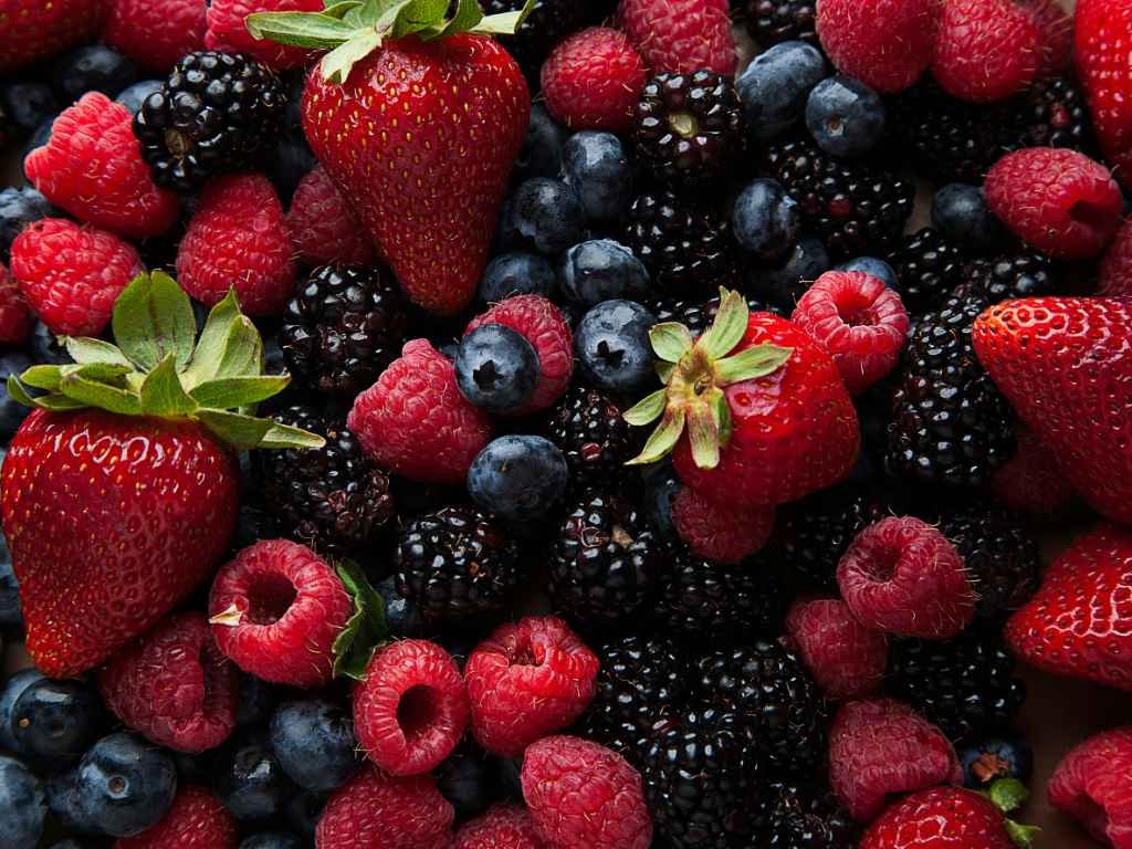 Fresh mixed berries including strawberries, blueberries, raspberries and blackberries - top antioxidant snacks for active individuals
