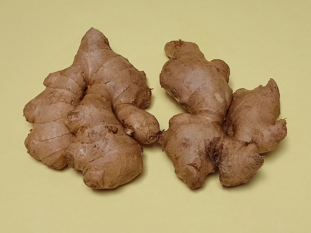 Fresh ginger root superfoods for immunity with natural anti-inflammatory properties on neutral background