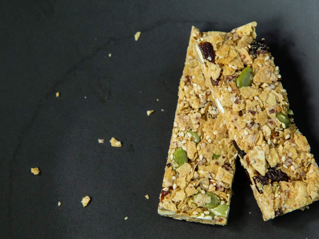 Low carb no sugar vegan protein bars with seeds and nuts on dark slate background