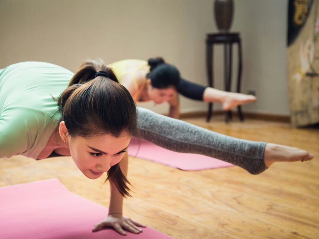 Woman doing yoga showing long-term fitness benefits of metabolism boosting spices in diet