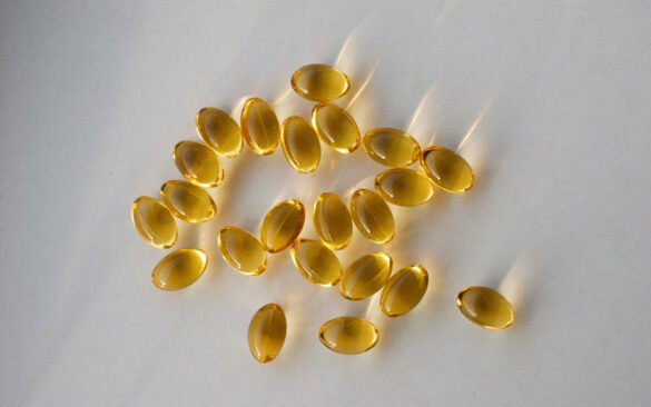 Golden multivitamins soft gel capsules arranged on white background with natural lighting, showing daily multivitamins for enhanced health benefits