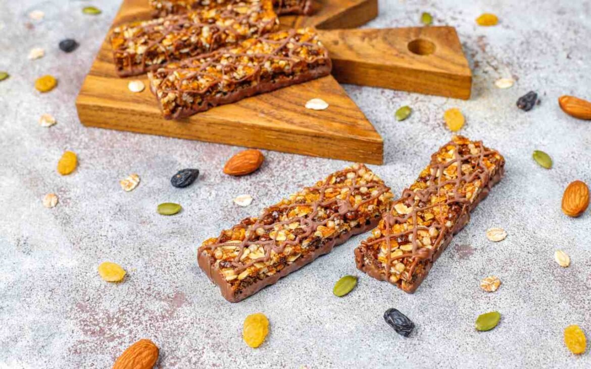 Homemade no sugar vegan protein bars with nuts and seeds on wooden cutting board