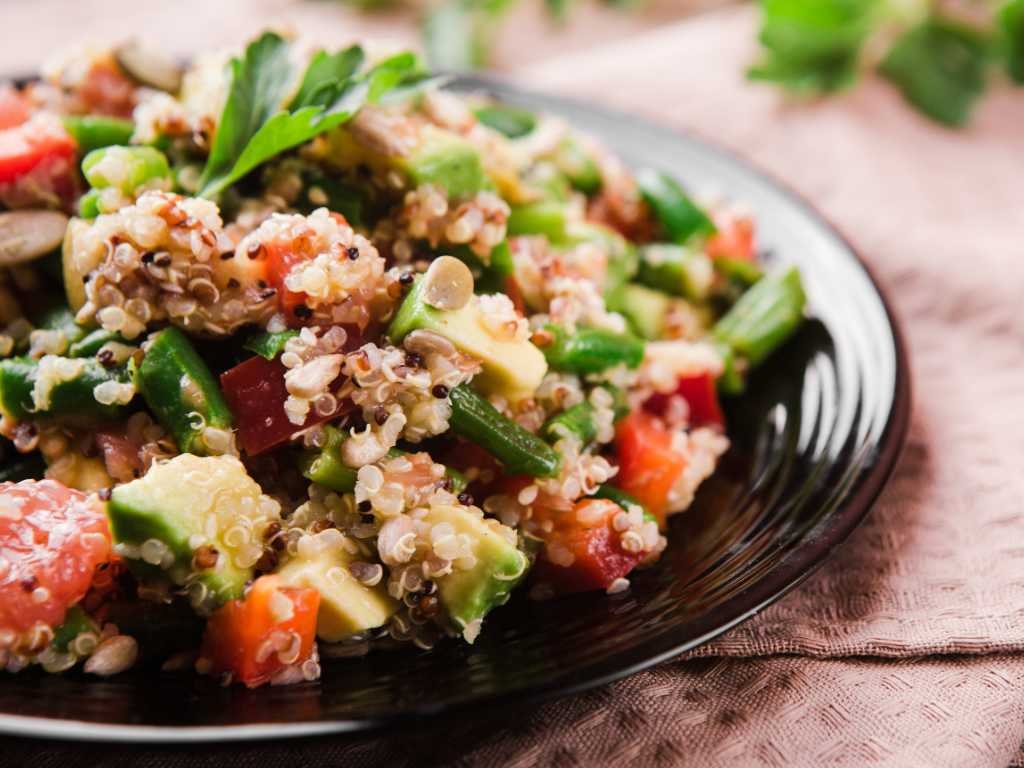 Fresh quinoa and edamame salad with vegetables - nutrient-dense plant-based protein snacks perfect for energy and muscle recovery nutrition