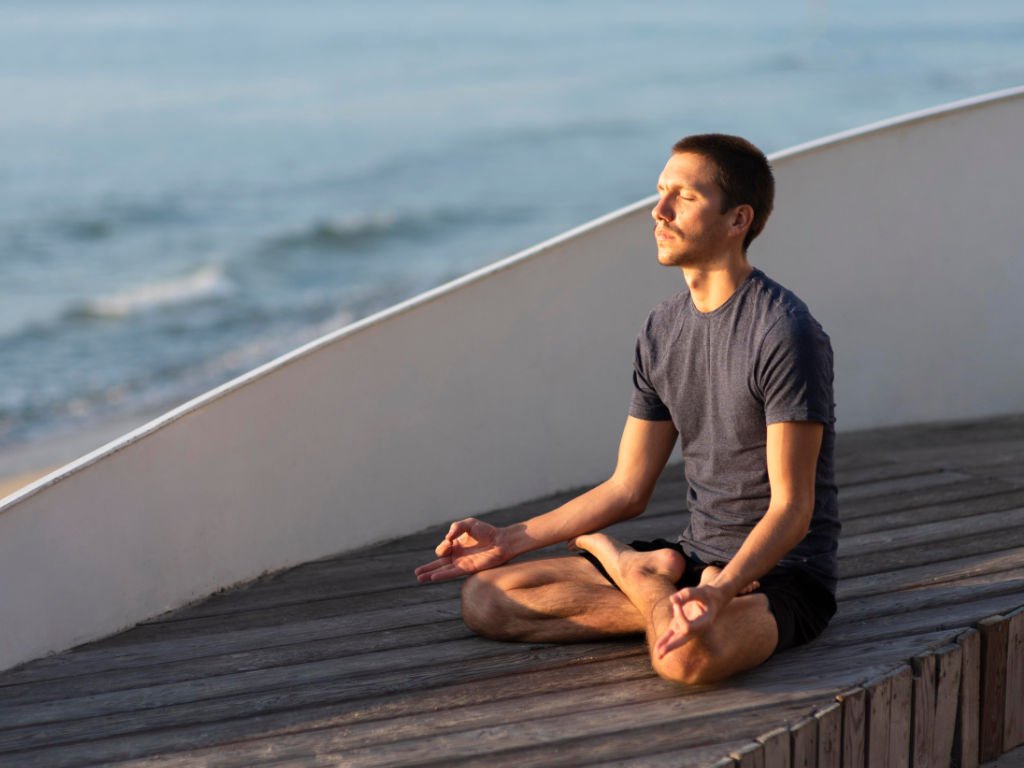 Man practicing meditation for stress management as part of natural sleep aids routine to calm the mind