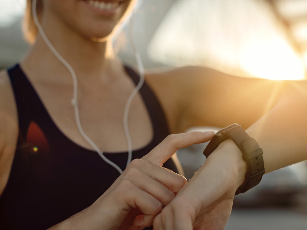 Woman checking smartwatch displaying fitness data as part of modern fitness gadgets for women technology