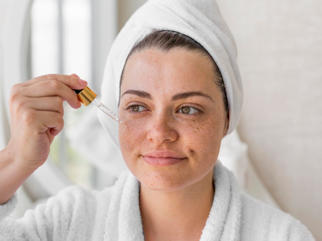 Woman applying hydration serum with dropper as part of water-based skincare routine for enhanced beauty and skin revitalization